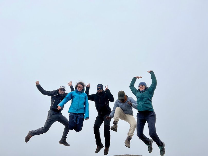 Hikers practicing uphill walking and stair climbing with backpacks in natural terrain