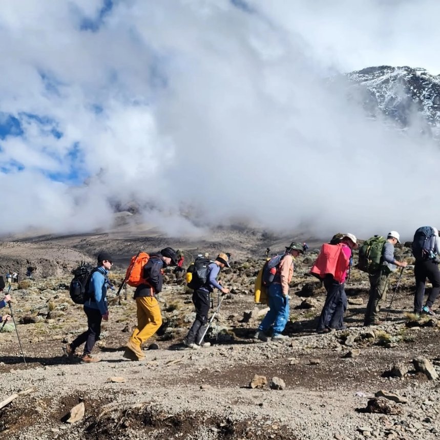 Climbers hiking through alpine desert near Lava Tower at high elevation