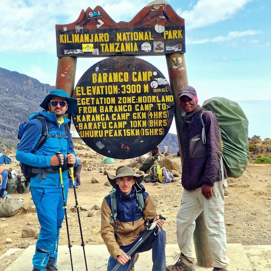 Trekkers climbing the famous Barranco Wall section on the Lemosho Route