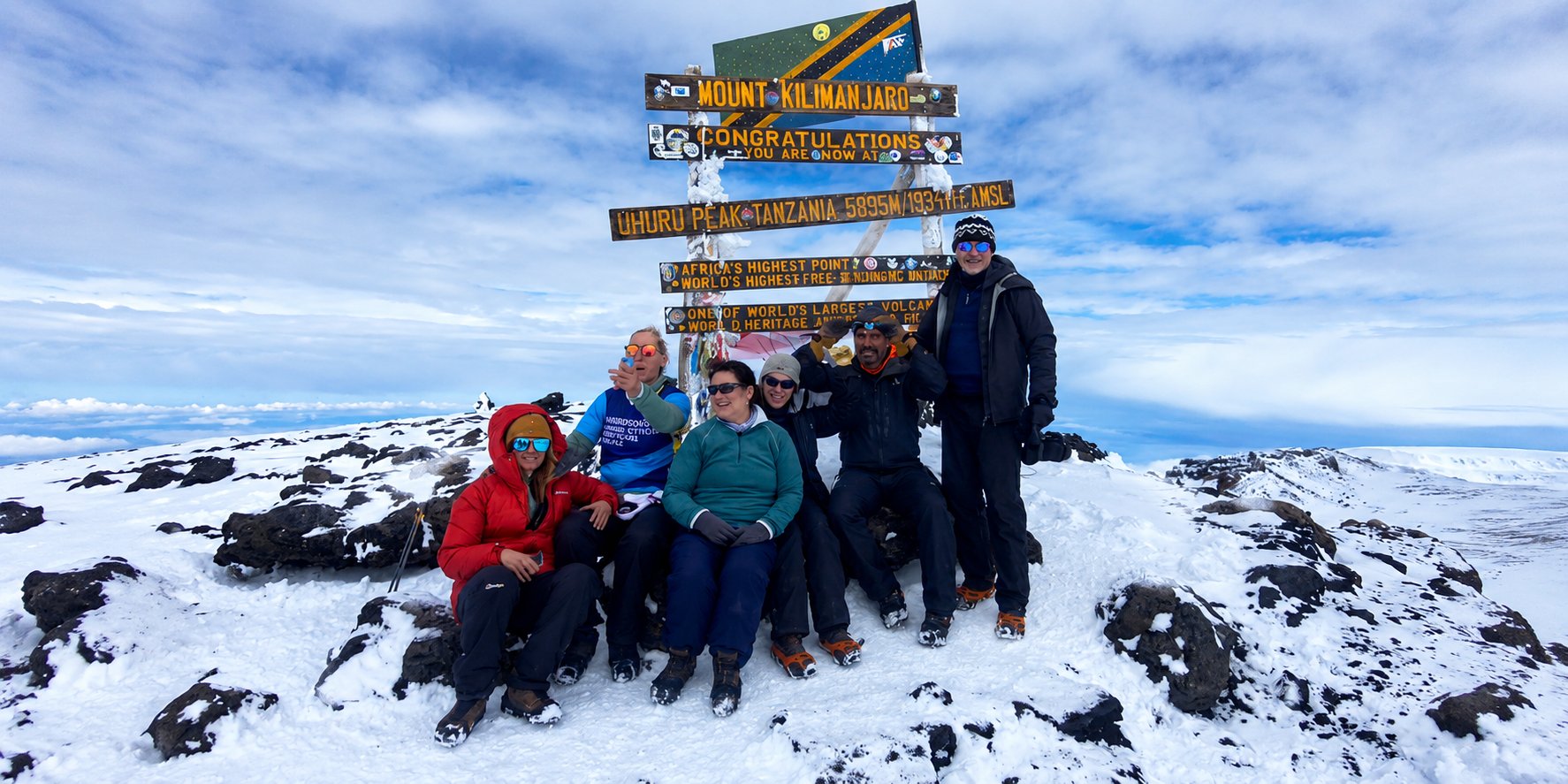 Trekkers hiking on Mount Kilimanjaro near Stella Point with glacier views