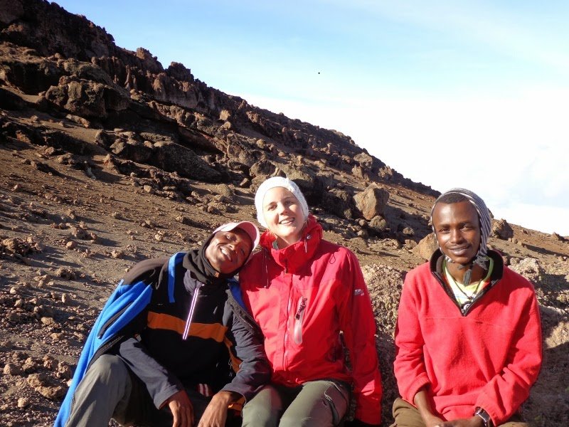 Climbers approaching Uhuru Peak during sunrise on Mount Kilimanjaro via Marangu Route