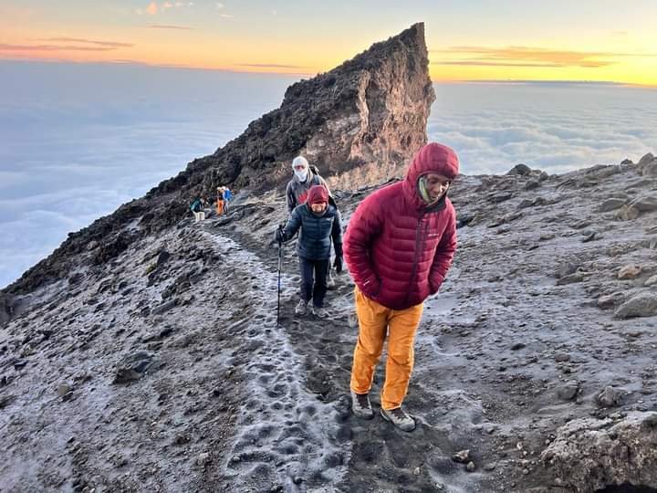 Climbers hiking toward Uhuru Peak during cold summit night