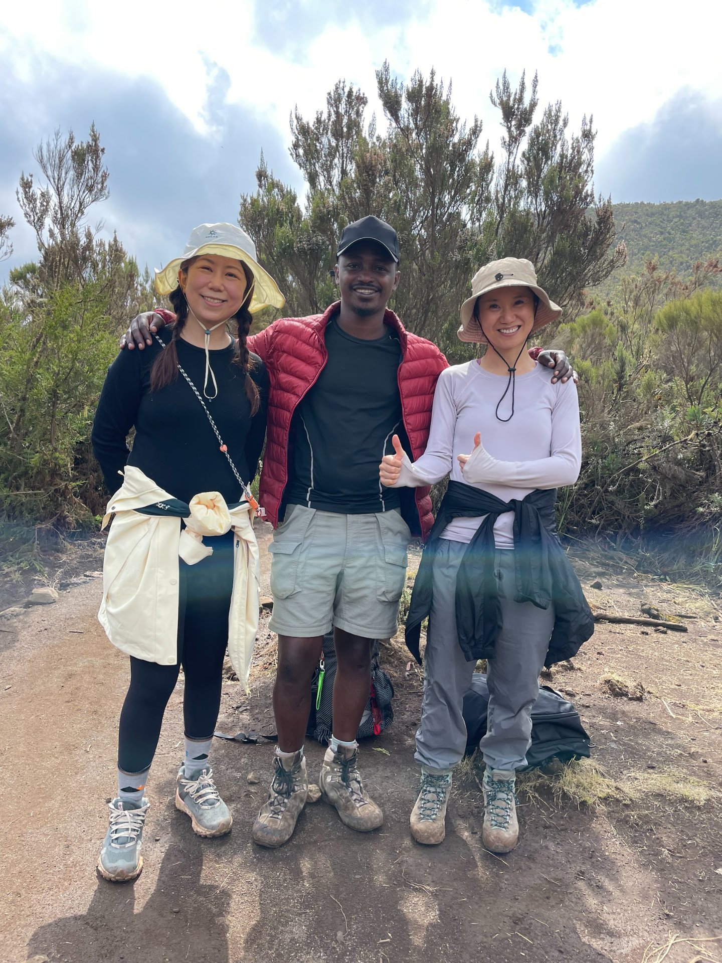 Founder of Climb2Kili Adventures standing with clients on Mount Kilimanjaro