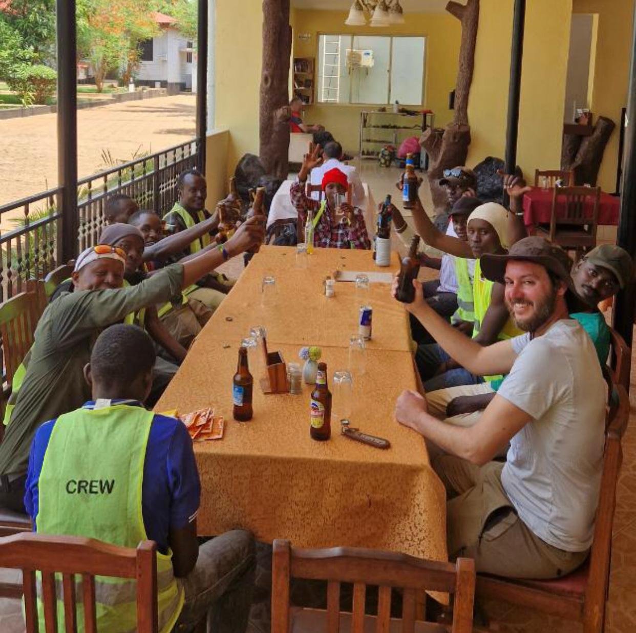 Guides, porters, chefs, and support team preparing for a Kilimanjaro expedition in Moshi