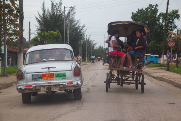 classic car next to horse drawn carriage