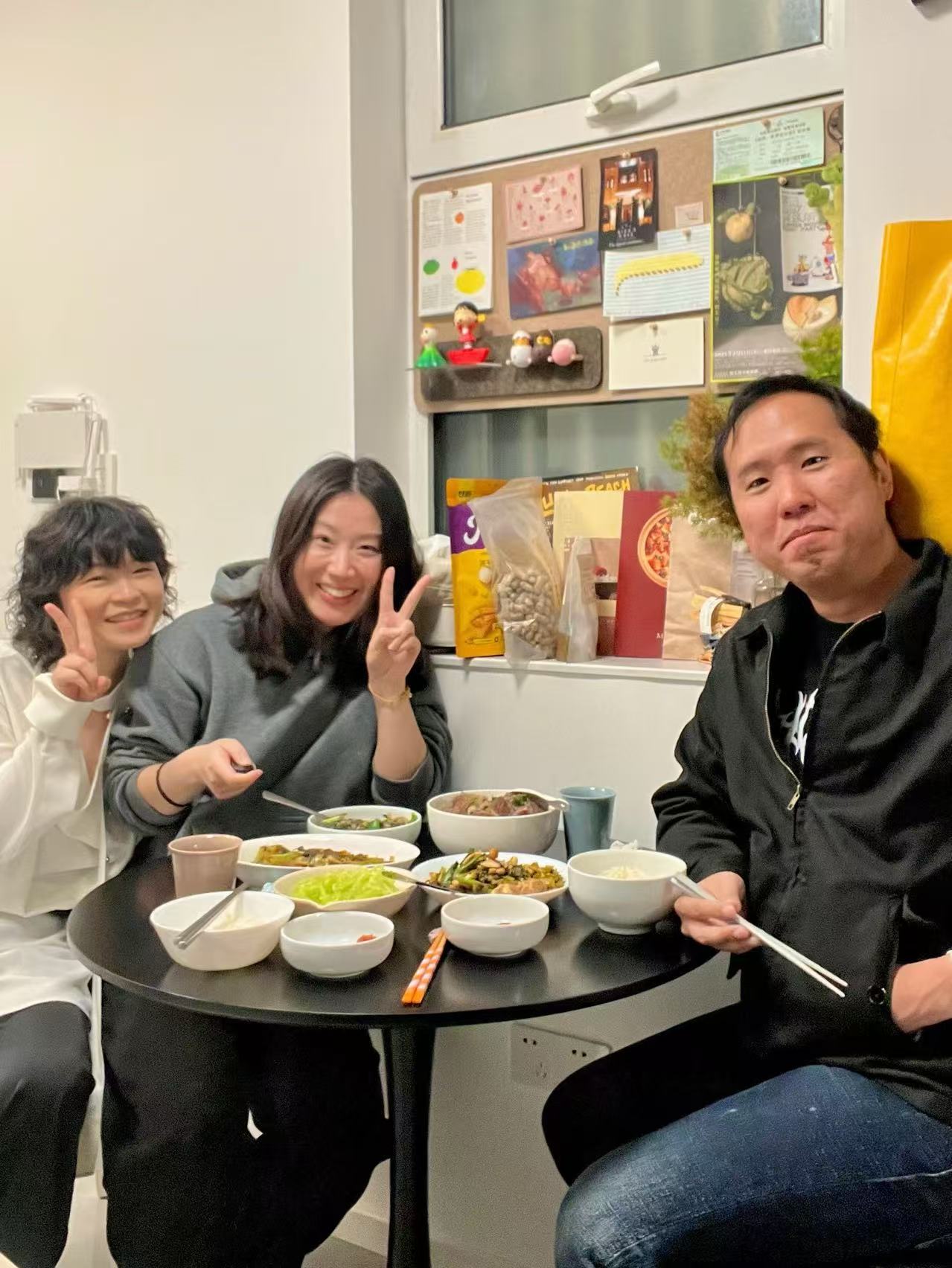 A solo traveler from Singapore enjoying a six-course Guangxi home dinner with local hosts in Shanghai