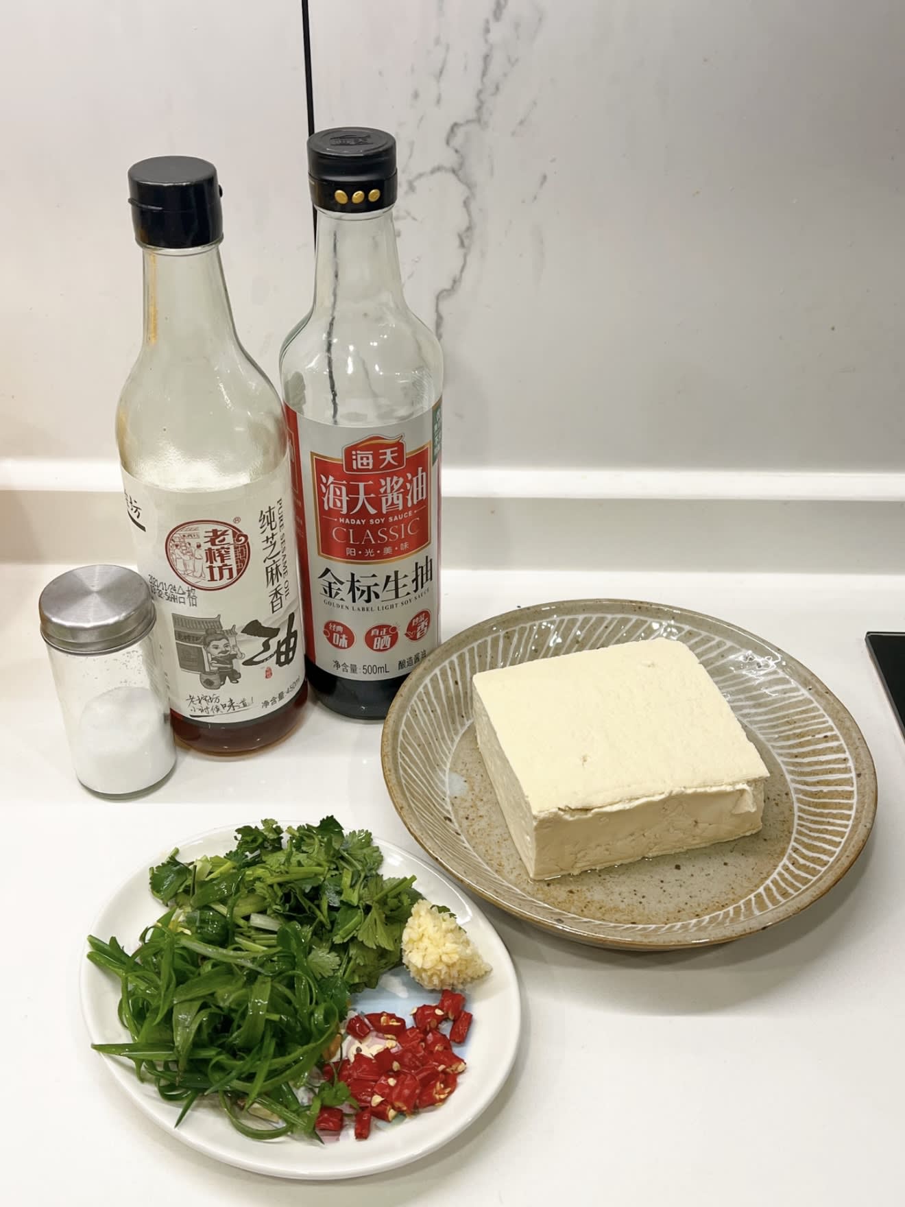 Tofu, herbs, chilli and seasonings arranged for prep in Yiting's kitchen