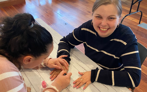an Everyday Ability Worker painting a Clients fingernails