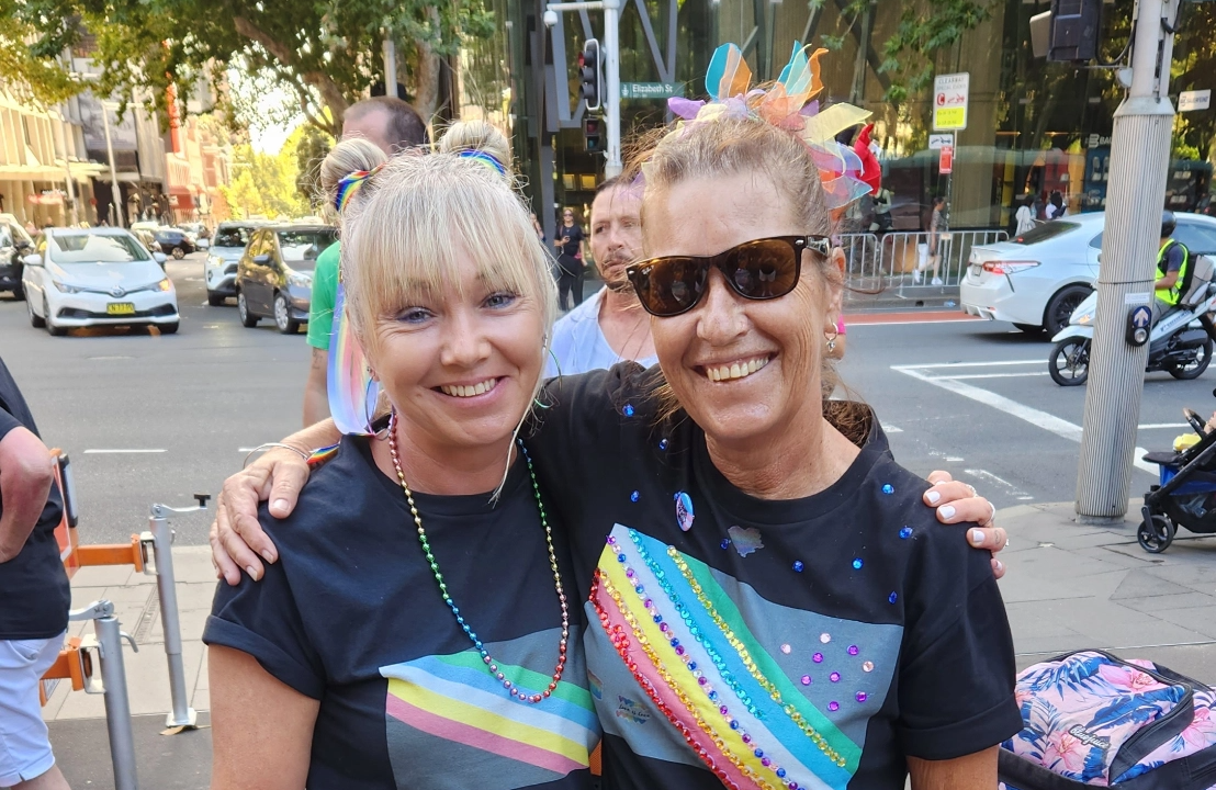 Two people on street at Mardi Gras event