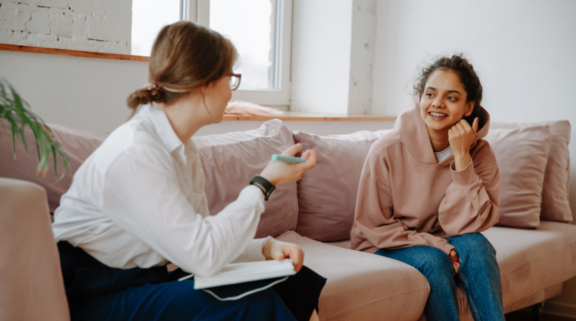 Two people talking on a couch