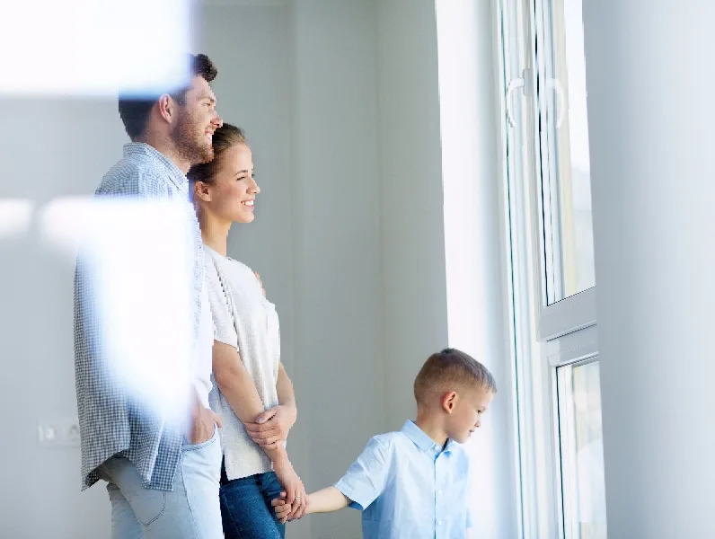 People by window, couple with child