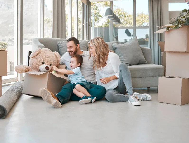 Family, People, Real Estate Concept, Happy mother father little son looking through window new home apartment