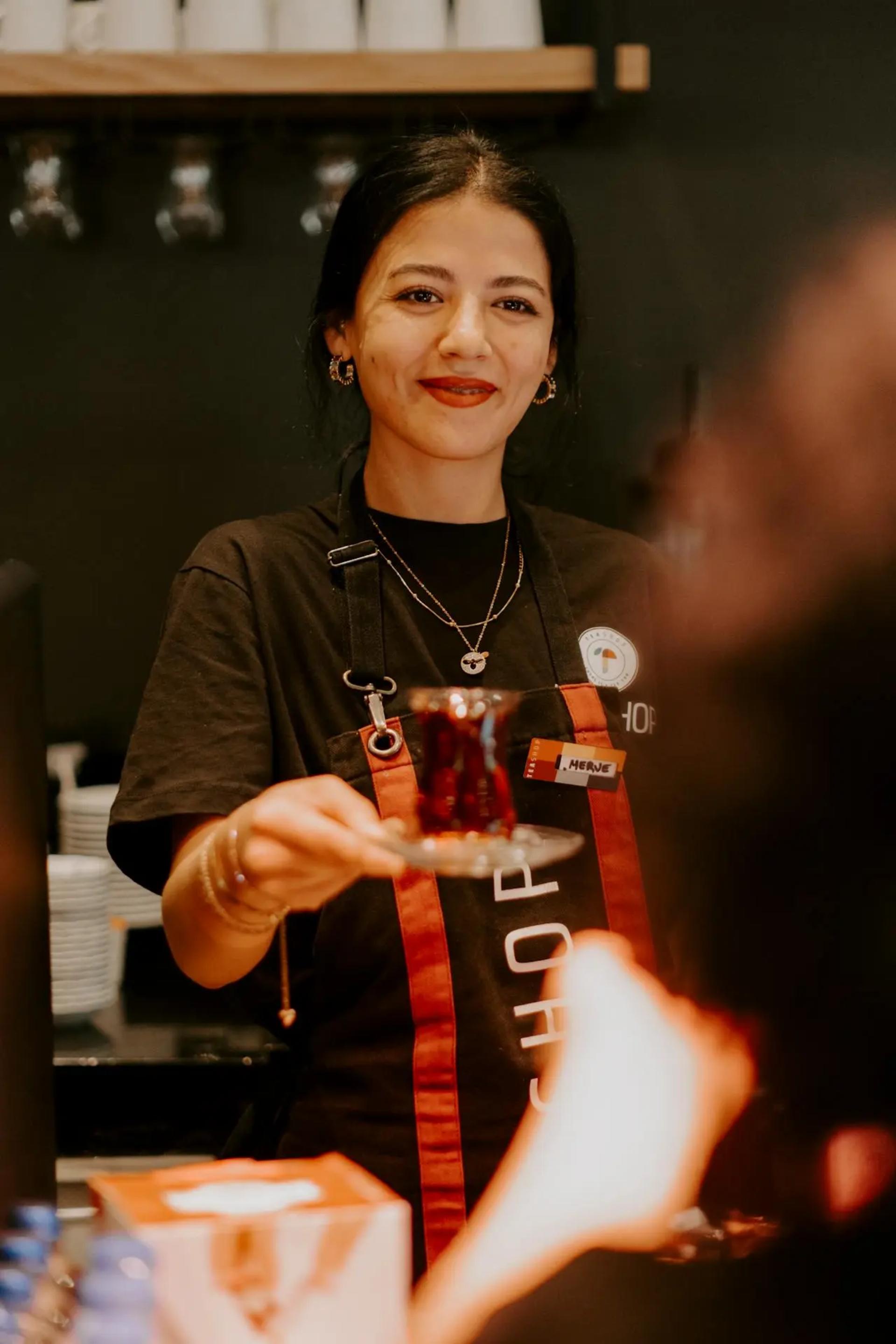 female small business owner serving customer in restaurant