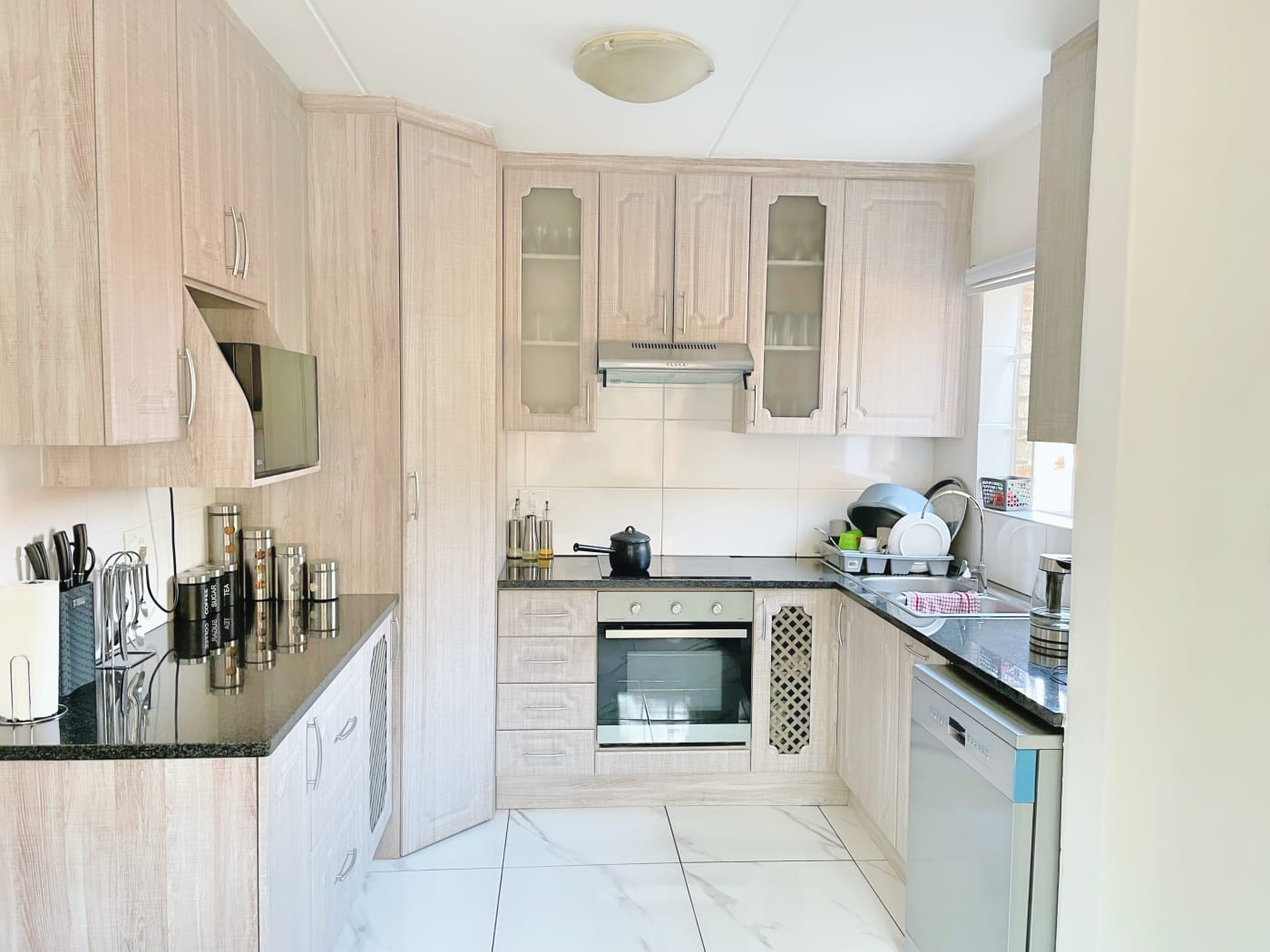 Sleek contemporary kitchen designed by Adornar Interior Designs
