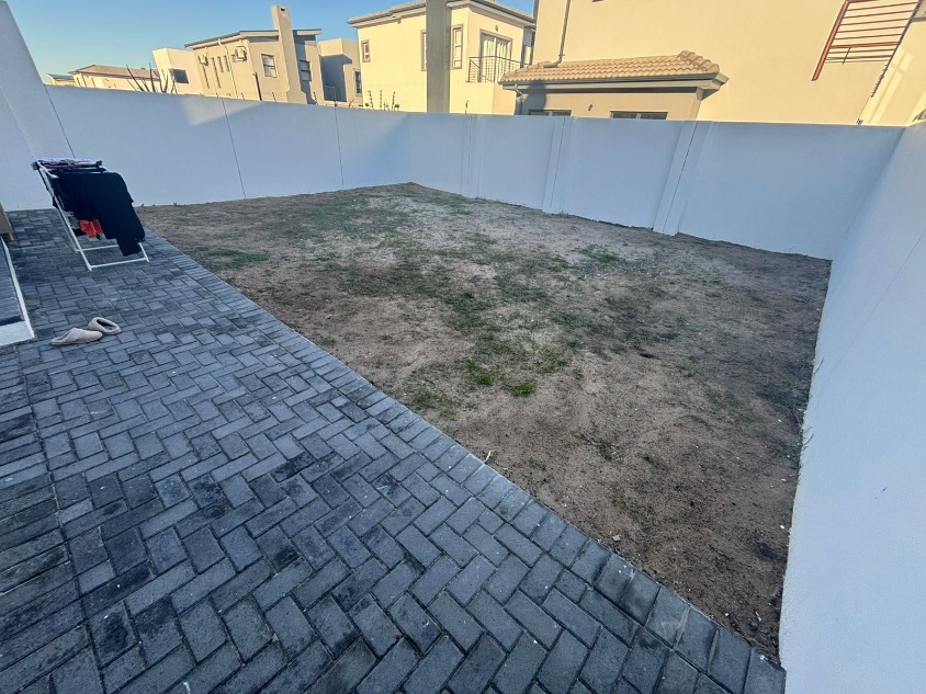 Before - Artificial grass and paving project in Table View