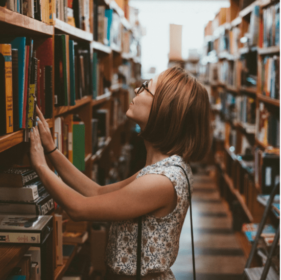 A girl looking at books in a library