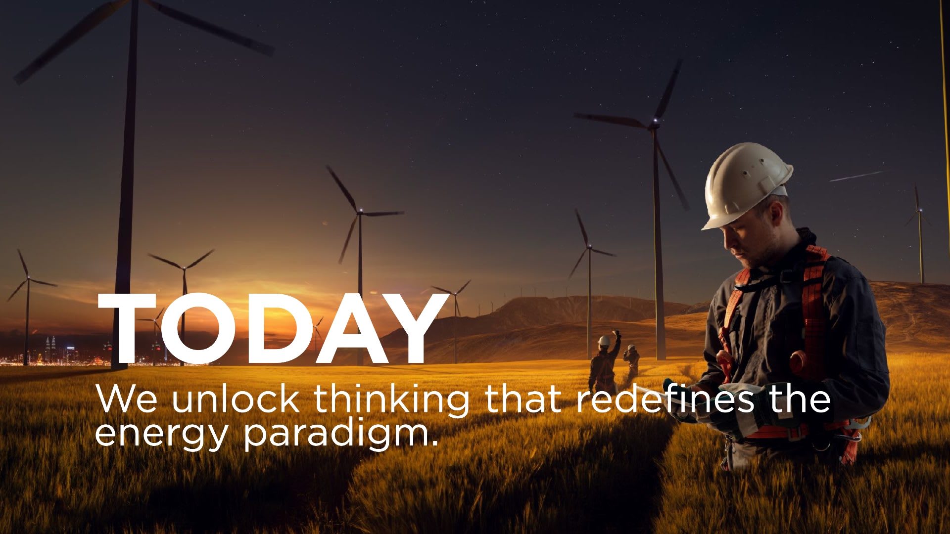 Chevron New Energies, slide reading Today. We unlock thinking that redefines the energy paradigm, over wind turbines at dusk