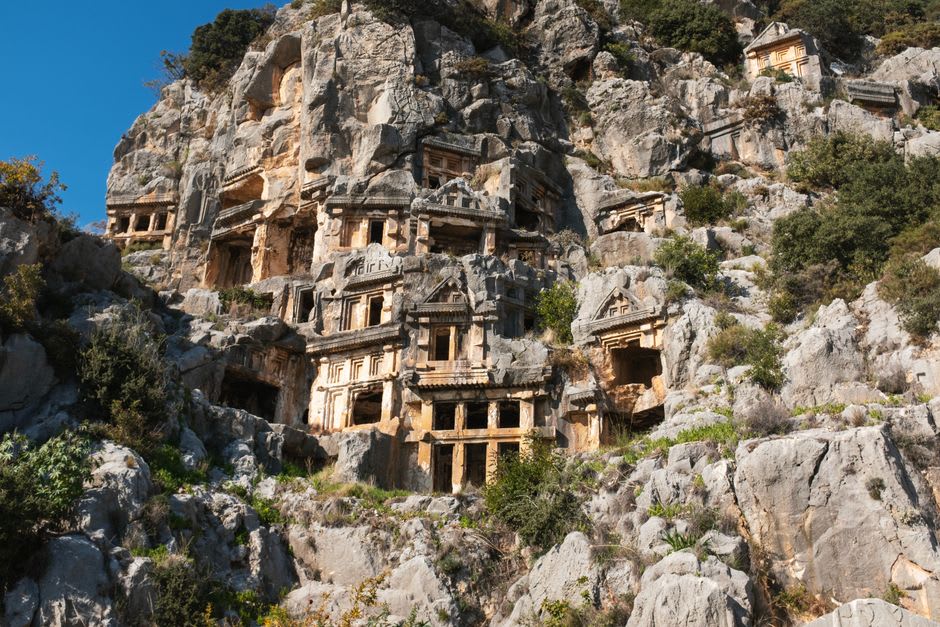 Lycian sarcophagi standing among modern buildings in central Fethiye, their ancient stone incongruous against contemporary shopfronts