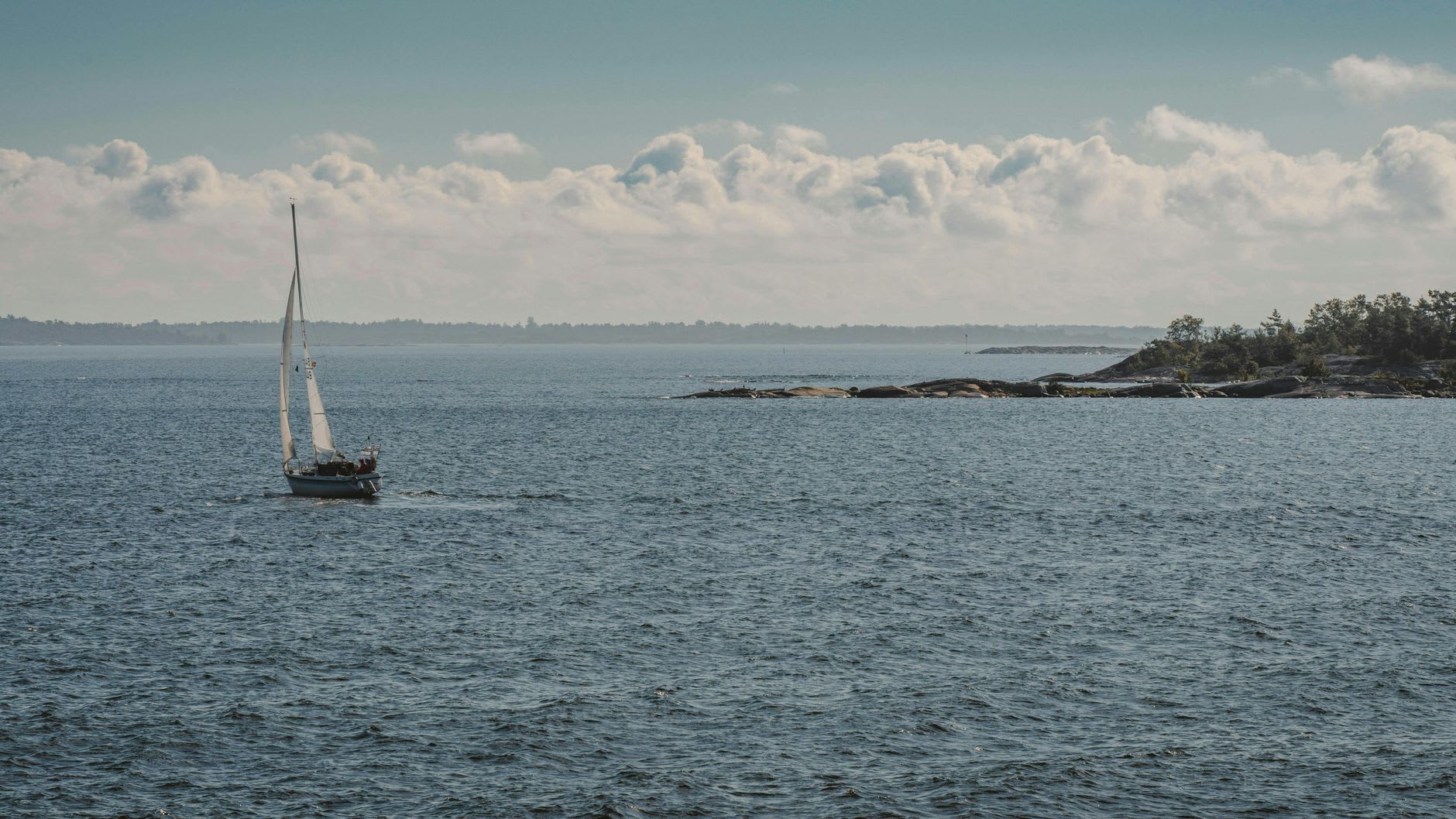 The four-masted barque Pommern moored at Mariehamn's eastern harbor, her dark hull reflected in still morning water