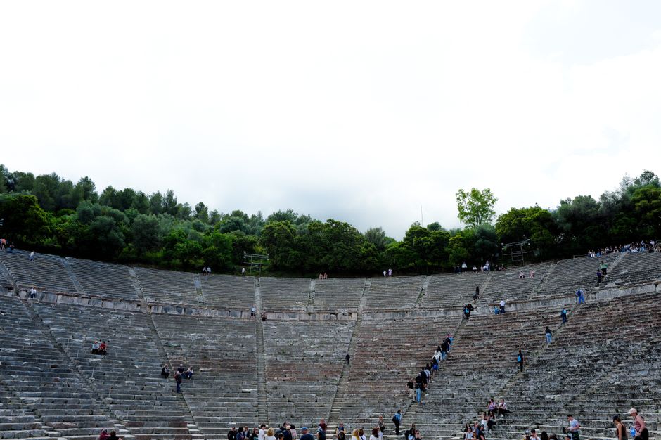 The ancient Greek theater of Butrint set into a hillside surrounded by dense green forest