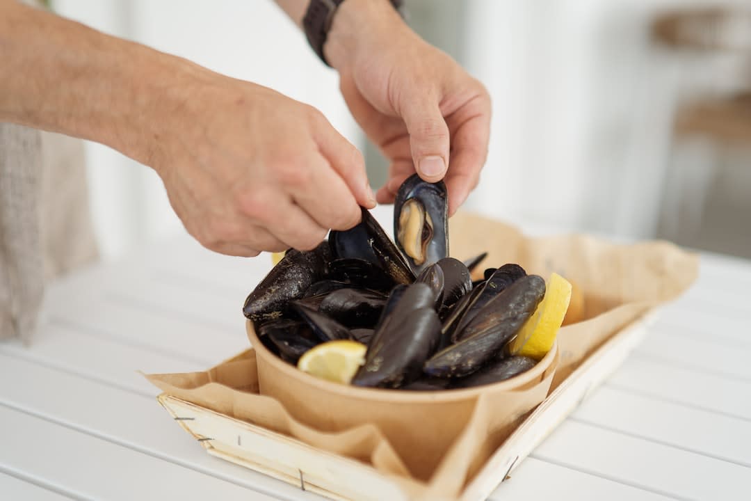 A plate of steamed mussels in white wine sauce served at a seaside restaurant in Vlorë