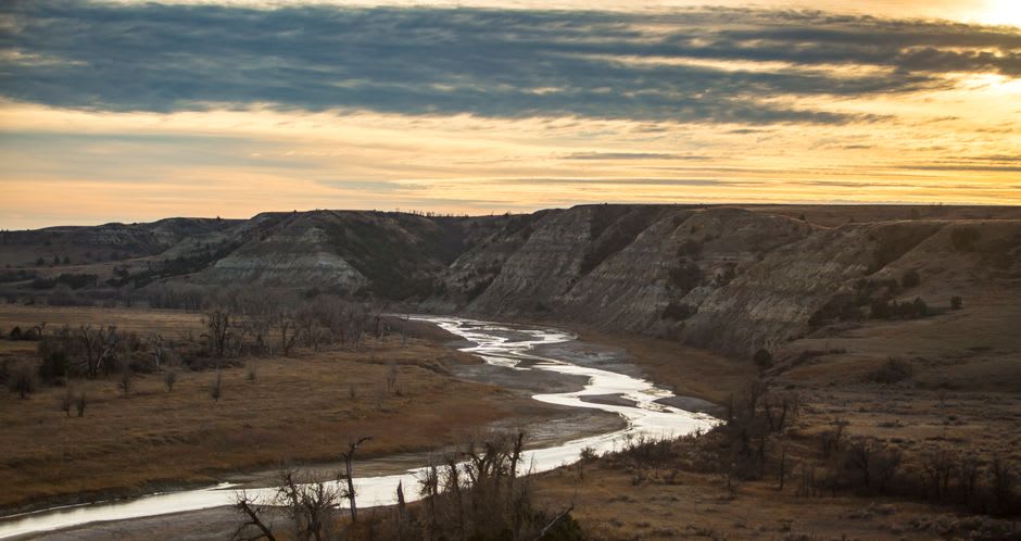 Sandstone bluffs and river valley bottomland at Police Point Park in Medicine Hat, cottonwood trees lining the South Saskatchewan River