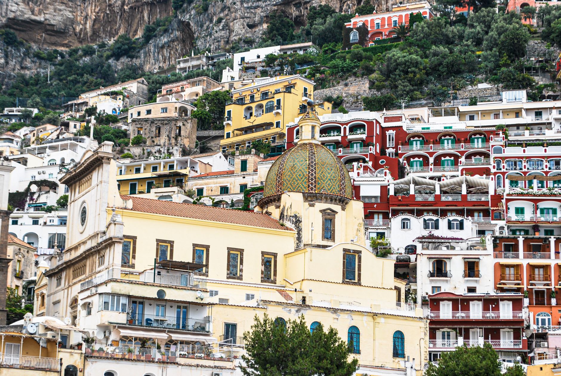 The majolica-tiled dome of San Giovanni Battista church in Vietri's upper district, with the Gulf of Salerno spreading below