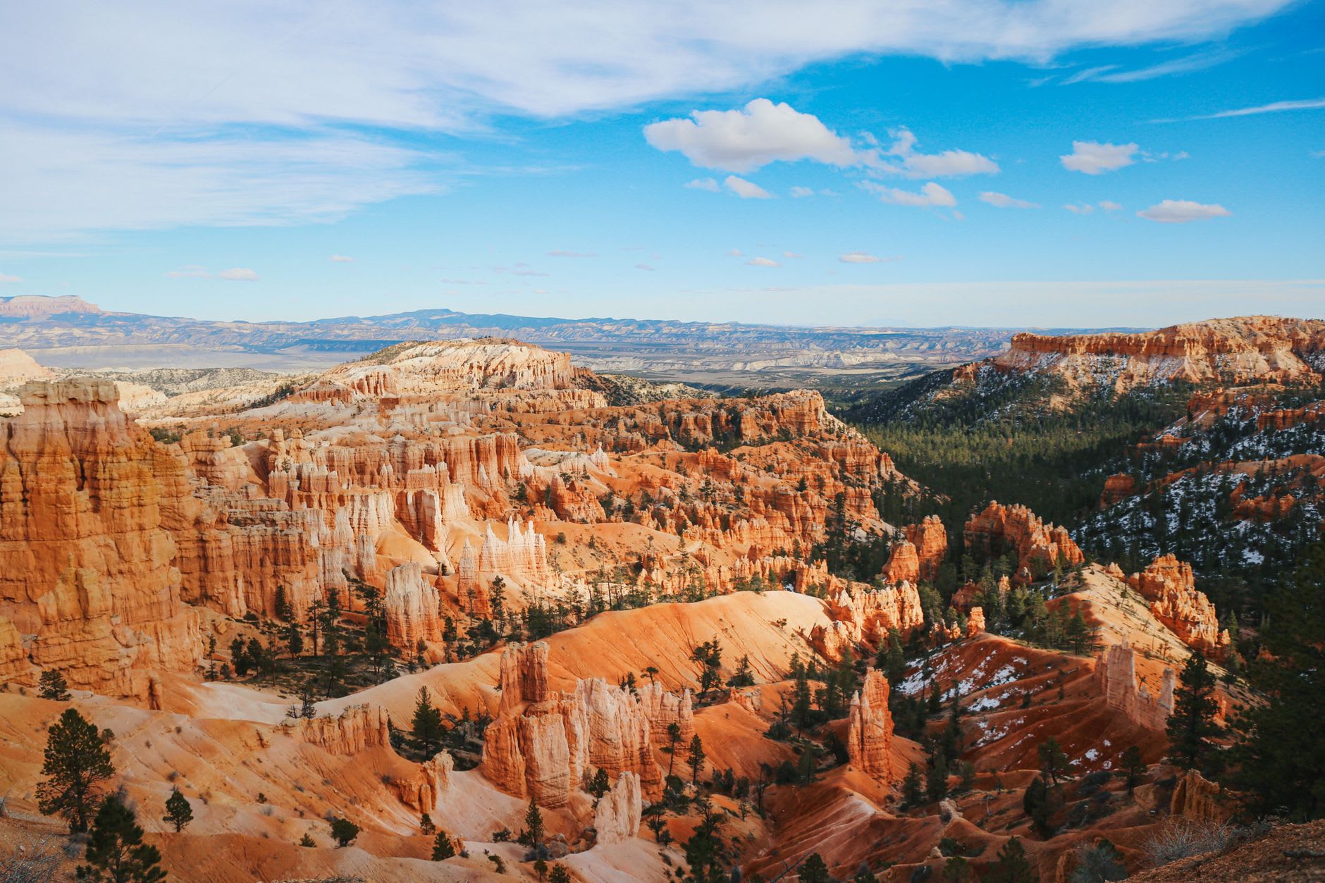 Two hikers dwarfed by the towering hoodoos along the Navajo Loop trail in Bryce Canyon's amphitheater