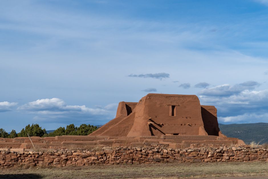 Pueblo Bonito's curved sandstone wall with rows of small square window openings
