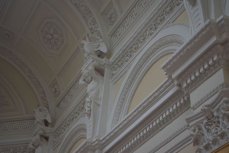An ornately carved stone doorway with neoclassical relief work on a former Greek mansion in Mustafapaşa