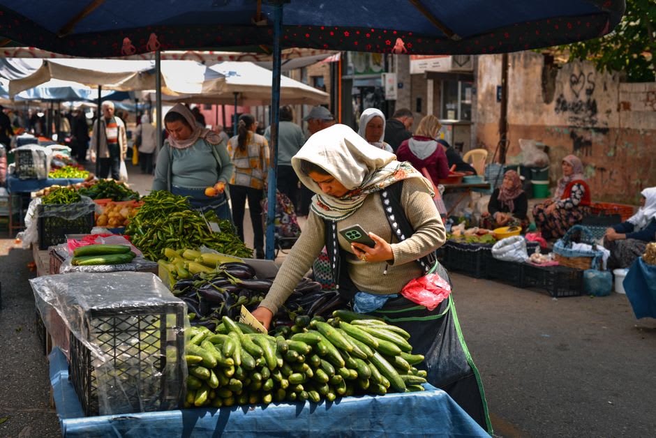 A wooden cart piled with dried apricots, walnuts, and local produce at the weekly Thursday market in Ürgüp
