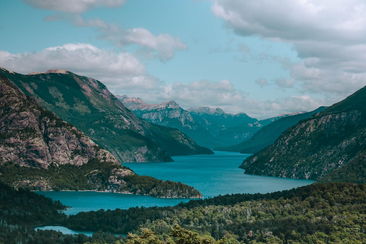Crystal-clear lake surrounded by snow-capped peaks in Bariloche