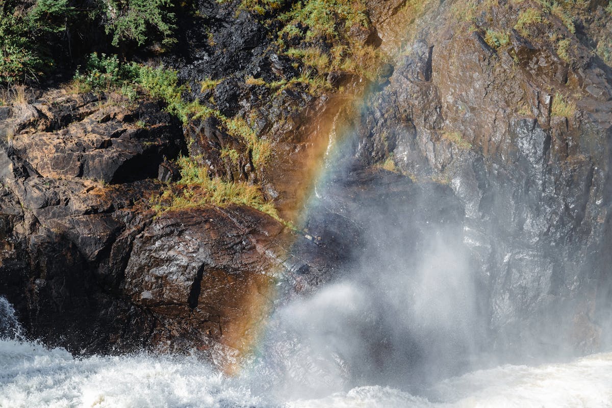 Rainbows forming in the mist above the thundering cascades of Iguazu