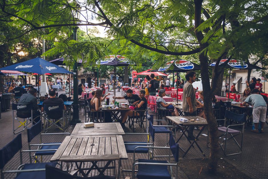 Crowded antique stalls along Calle Defensa during the Sunday feria in San Telmo