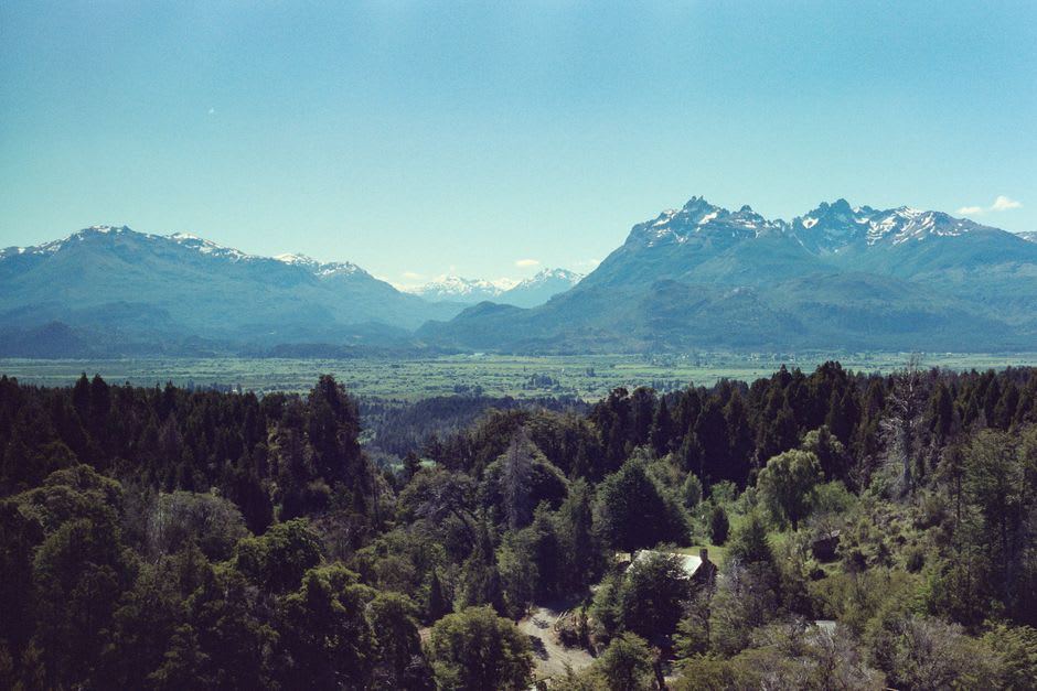 A whitewashed Welsh chapel with the Andes mountains rising in the background near Trevelin