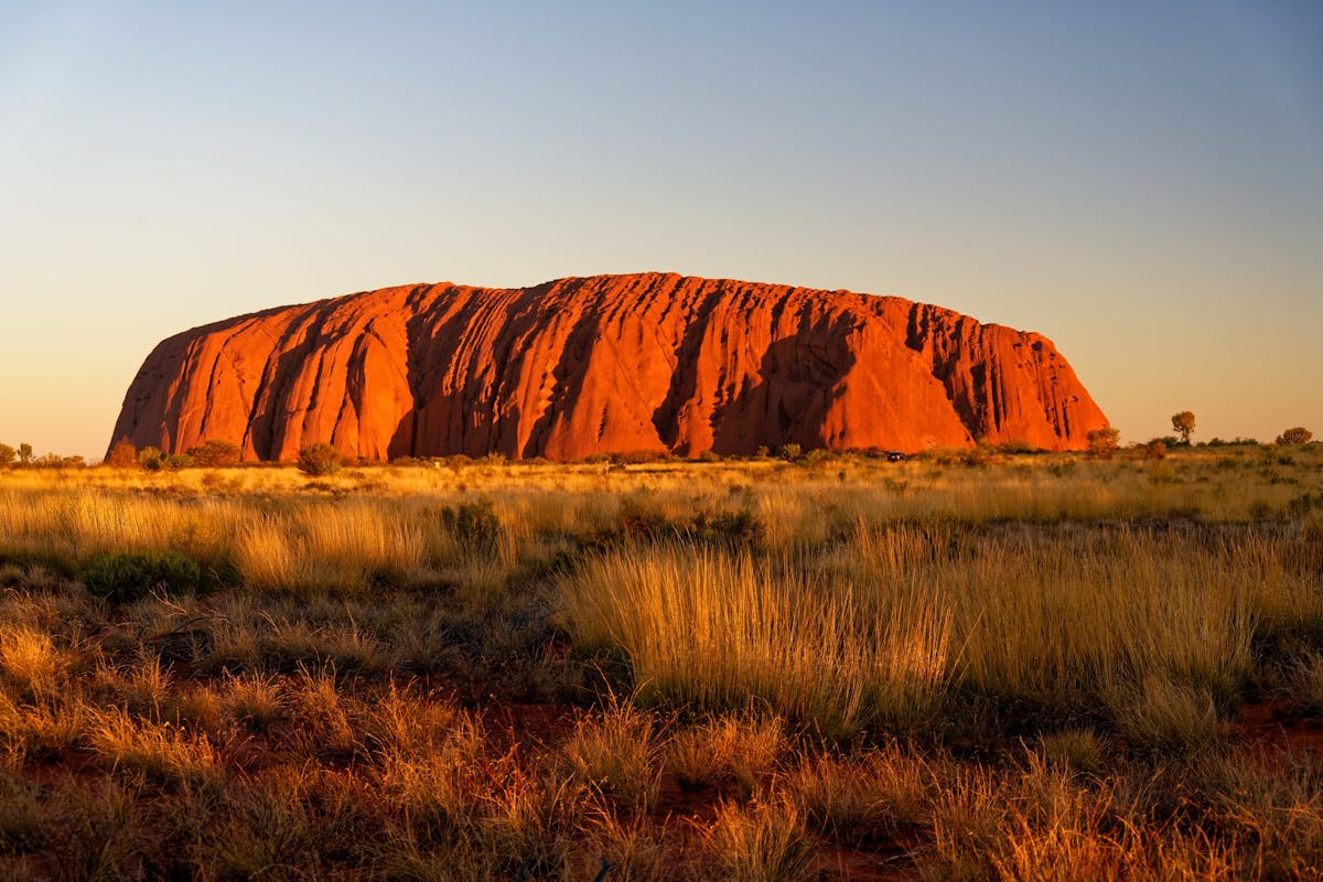 Uluru glowing deep red at sunset