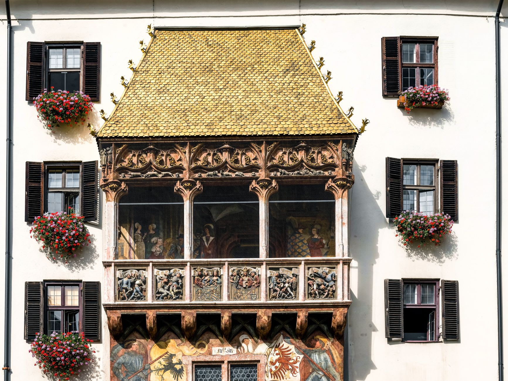 The Golden Roof's gilded copper tiles glowing against the blue Tyrolean sky in midday light