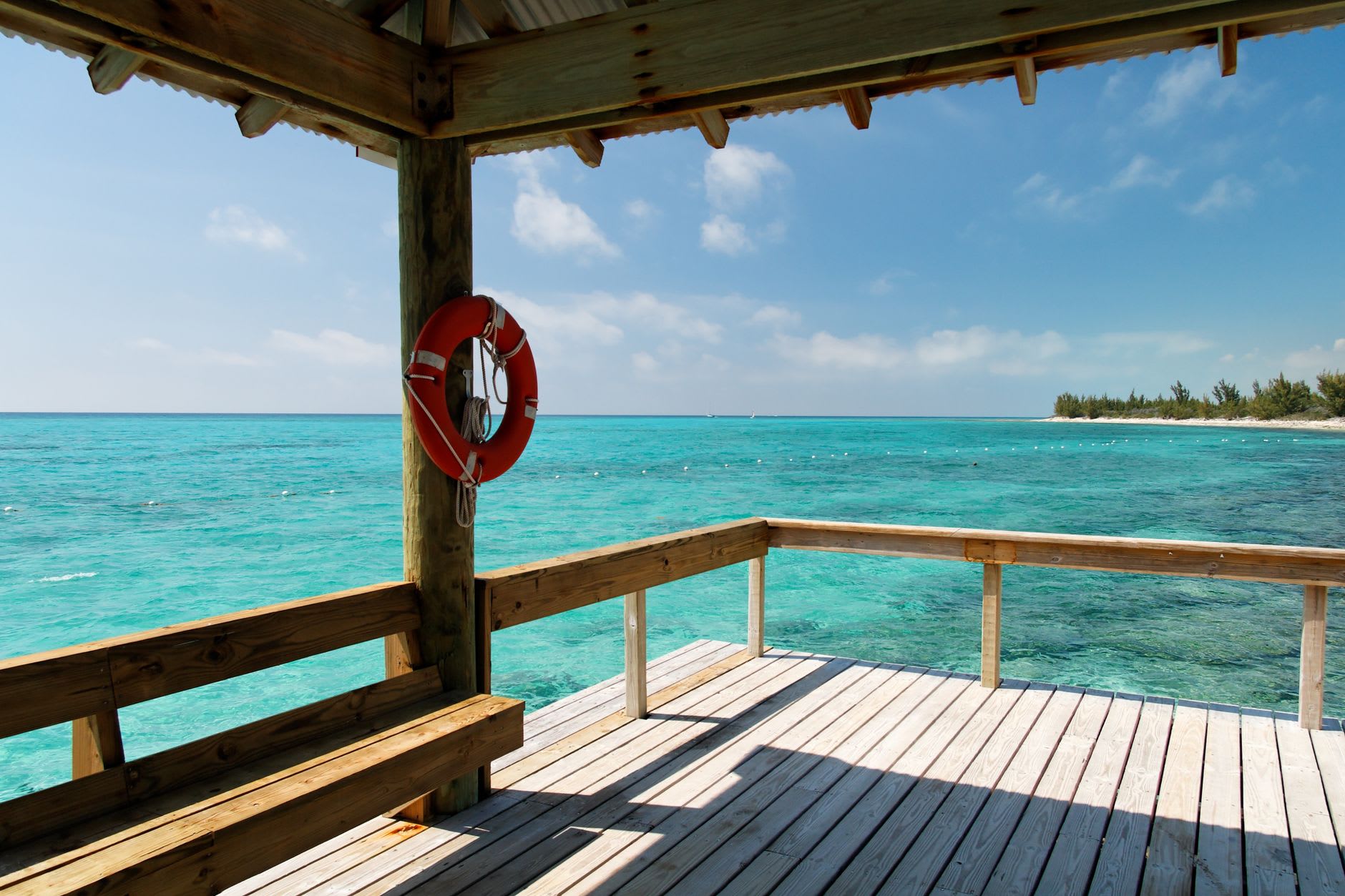Dean's Blue Hole from the beach, the dark circle of deep water surrounded by the clear shallows of the cove