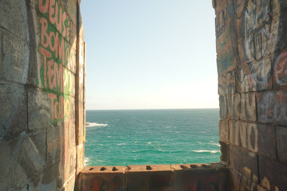 Ruined stone walls of Castelo Garcia d'Ávila overlooking the coastline at Praia do Forte