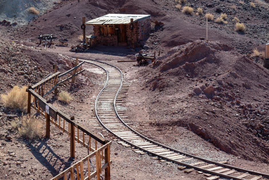 Weathered stone foundations of an abandoned silver mining operation on the shoreline near Bahía de los Ángeles with desert mountains behind