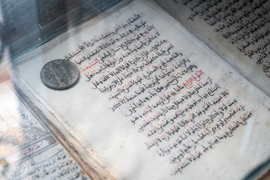 Mughal-era coins and manuscripts displayed in the archaeological museum inside Lalbagh Fort
