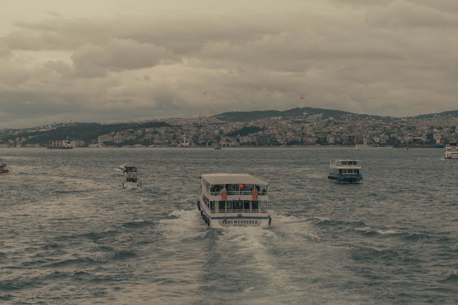 Small passenger ferry crossing the narrow channel of the Pasaia inlet between Donibane and San Pedro