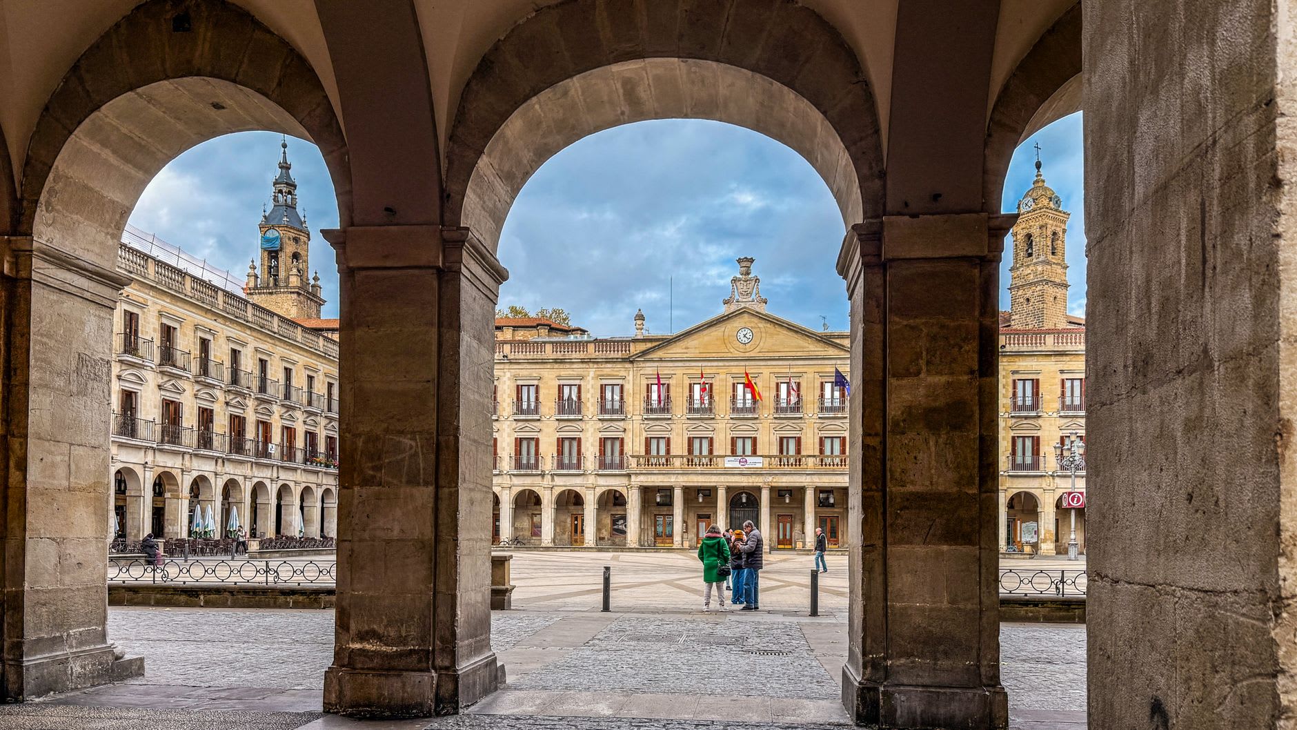 The exterior of the Cathedral of Santa María in Vitoria-Gasteiz, its Gothic stonework visible in the illuminated evening light