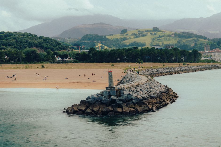 Low-tide rock shelves exposed beneath the flysch cliffs at Itzurun beach