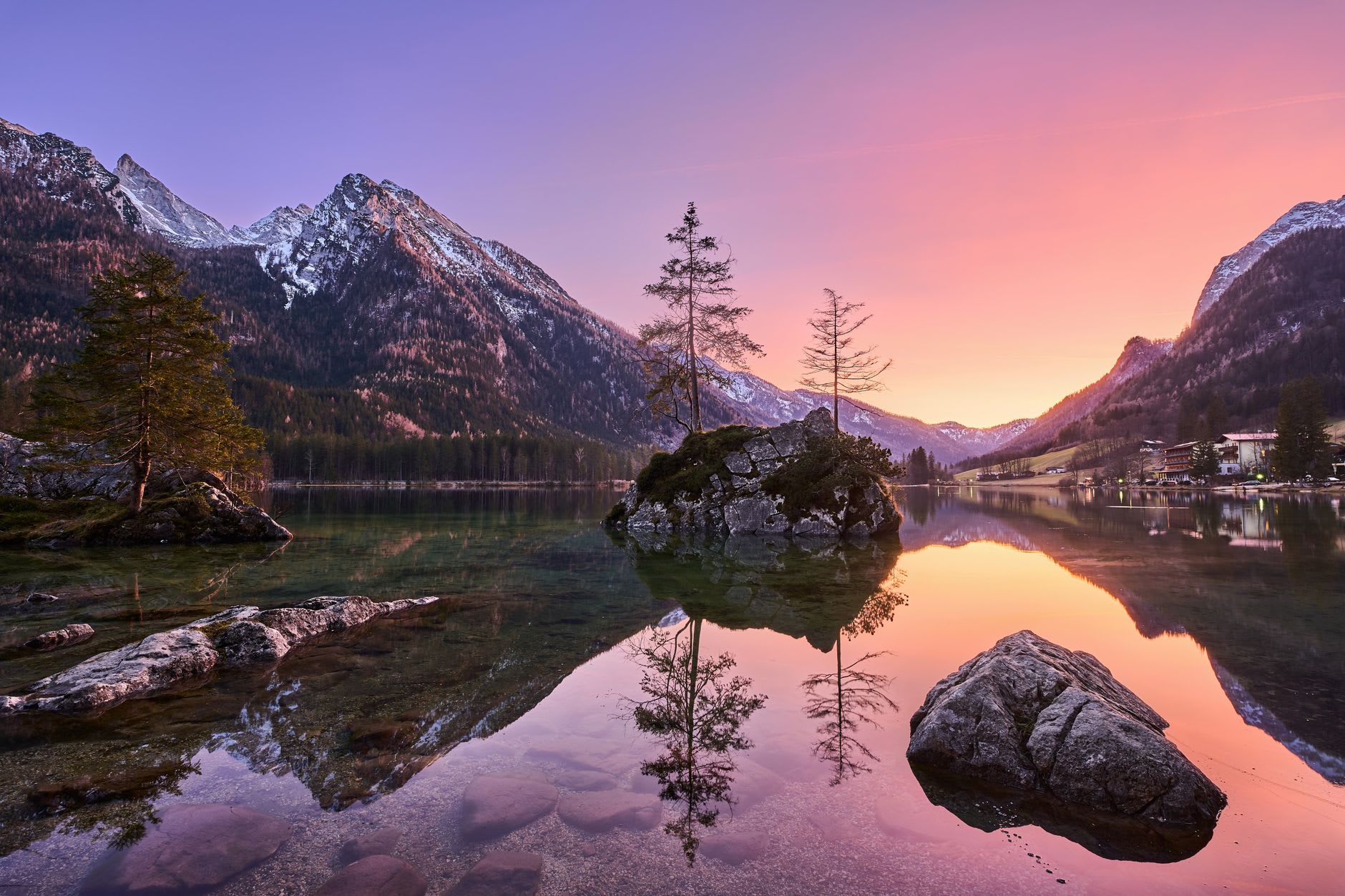 St. Sebastian church at Ramsau in autumn, Ramsauer Ache stream running clear below, low cloud on the mountains beyond