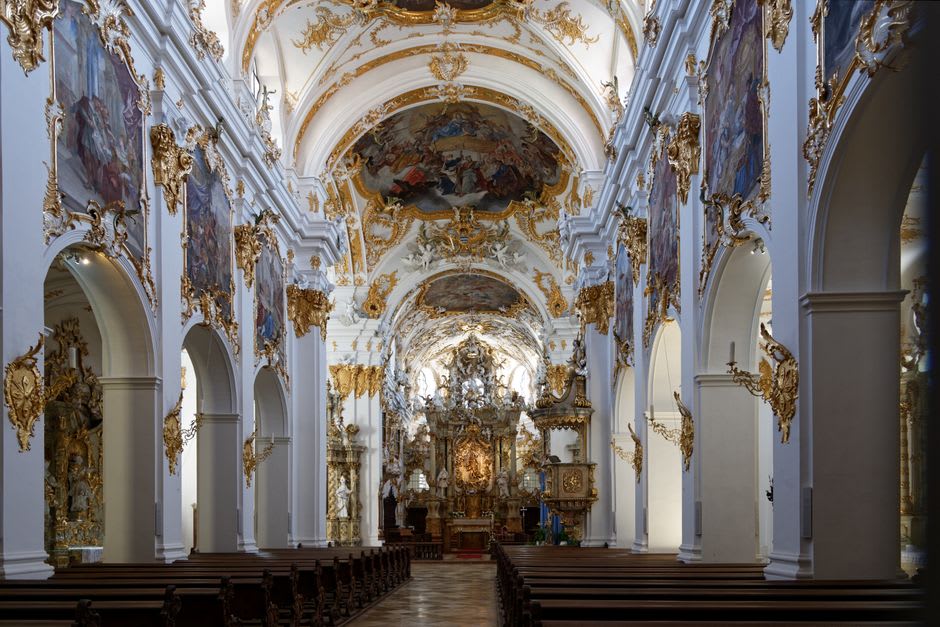Sunlight streaming through the tall windows of the Wieskirche onto the gilded interior