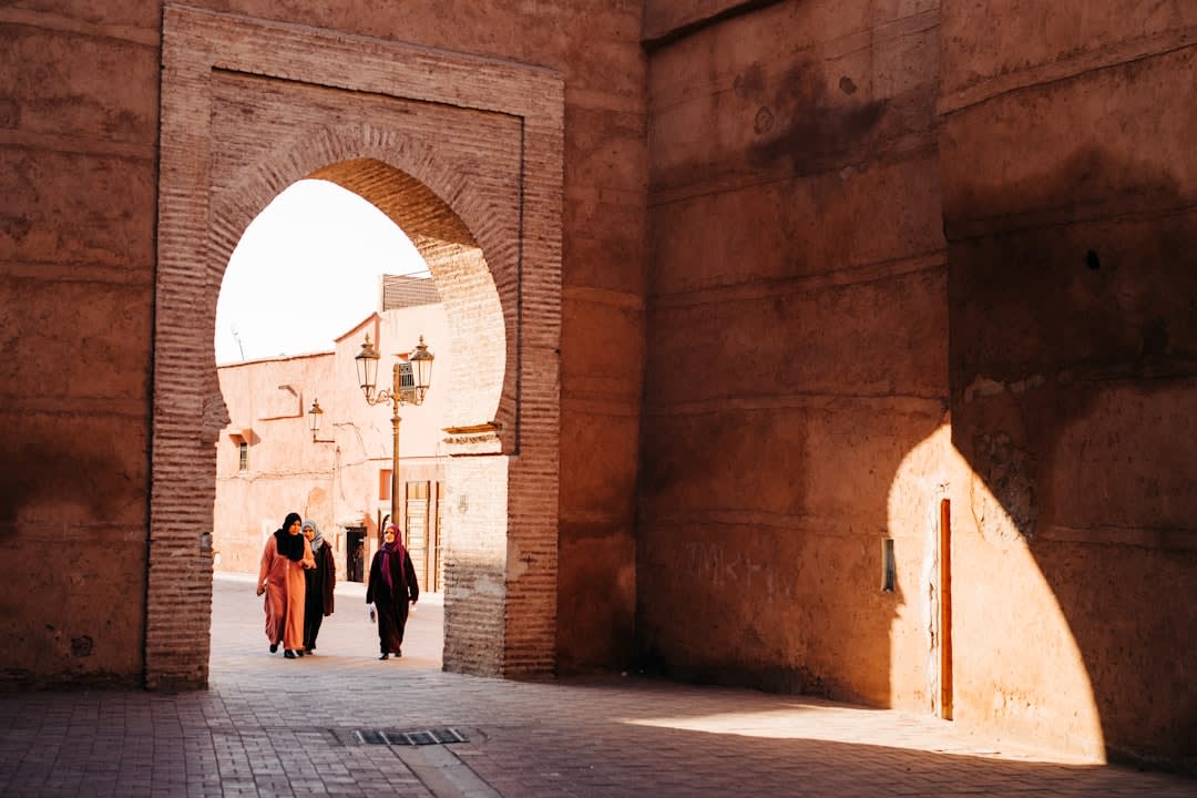 Vaulted stone arches of the old Ottoman souk in Rachaya, with a fruit seller's stall visible in the corridor