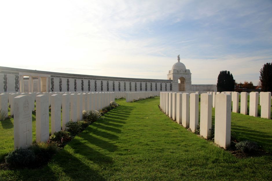 Rows of white headstones at Tyne Cot Cemetery near Ypres under an overcast sky