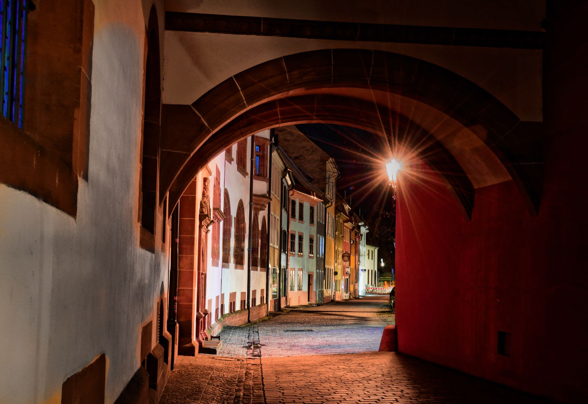 The Bächle channels running alongside a cobblestone pedestrian street in Freiburg's old town at golden hour