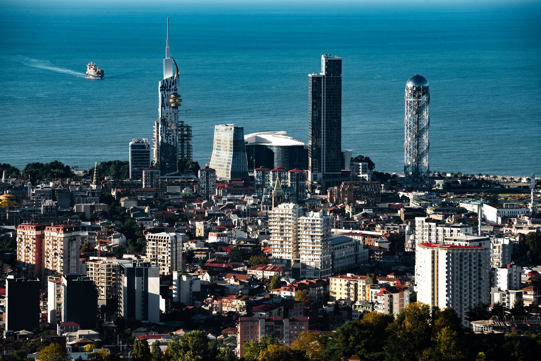 The Black Sea glittering below the cliffs of Batumi's botanical garden, container ship on the horizon